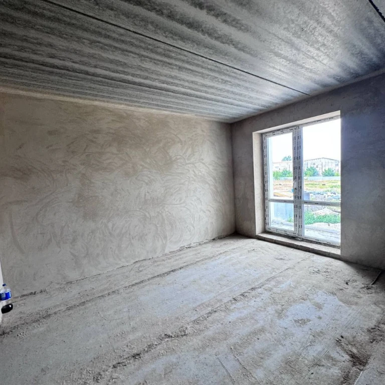 Spacious apartment with unfinished interior in a completed building,