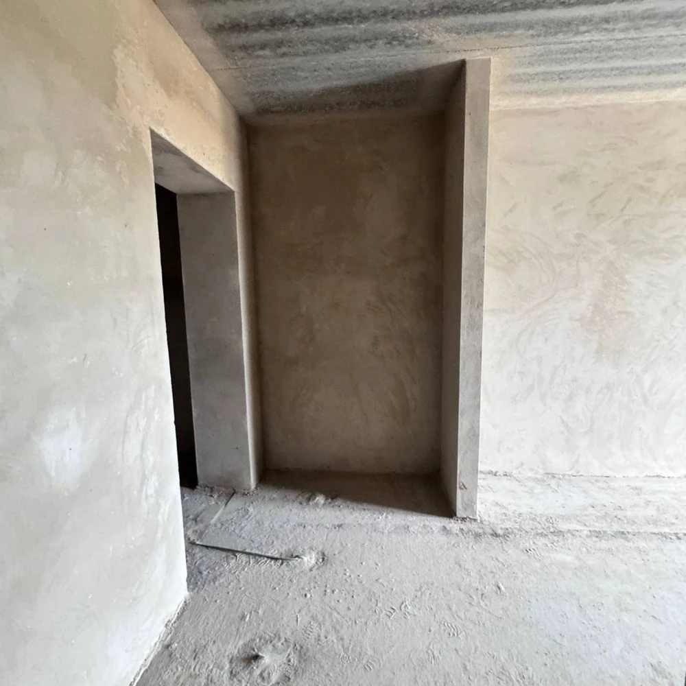Spacious apartment with unfinished interior in a completed building,