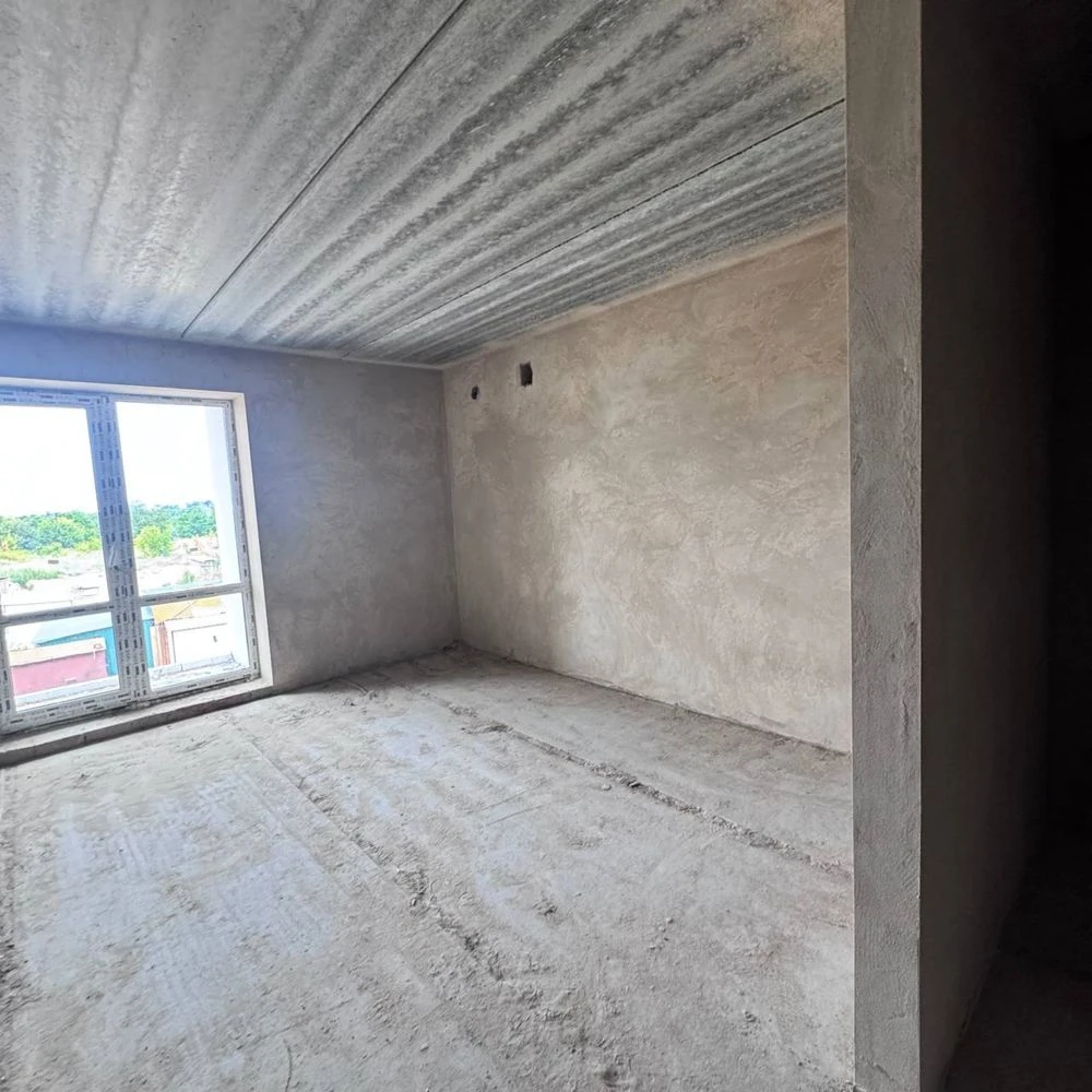 Spacious apartment with unfinished interior in a completed building,