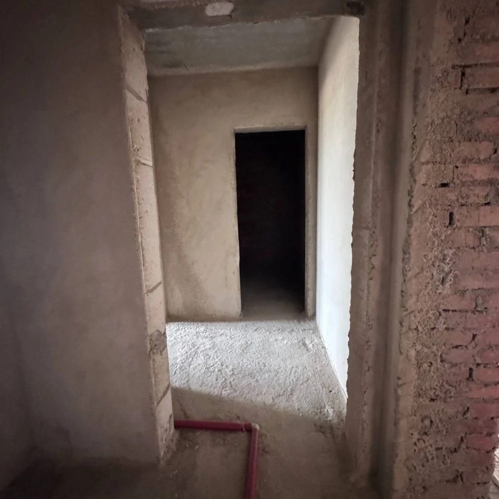 Spacious apartment with unfinished interior in a completed building,